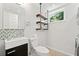 A laundry and half bath featuring wooden shelves, tile backsplash, and toilet at 481 Meadowbrook Se Dr, Marietta, GA 30067