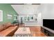 Open living space with hardwood floors, bright white kitchen, and stainless steel refrigerator at 481 Meadowbrook Se Dr, Marietta, GA 30067