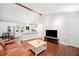 Bright open living area with hardwood floors, ceiling fan, and modern kitchen view at 481 Meadowbrook Se Dr, Marietta, GA 30067