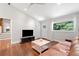 Cozy living room with leather sofa, hardwood floors, television and plenty of natural light at 481 Meadowbrook Se Dr, Marietta, GA 30067