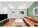 Light filled living room with hardwood floors, recessed lighting, and a leather sofa at 481 Meadowbrook Se Dr, Marietta, GA 30067
