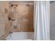 A modern bathtub with a shower, stylish tile surround and a crisp white shower curtain at 6851 Roswell Rd # G3, Atlanta, GA 30328