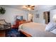 Comfortable bedroom with a ceiling fan, hardwood floors, and a large dresser at 6851 Roswell Rd # G3, Atlanta, GA 30328