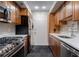 Modern kitchen with stainless steel appliances, quartz countertops, and rich wooden cabinets at 6851 Roswell Rd # G3, Atlanta, GA 30328