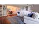 Bright living room featuring a comfortable sofa, blue accent pillows, and a dining area in the background at 6851 Roswell Rd # G3, Atlanta, GA 30328