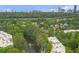 Scenic aerial shot of a community with a pond and fountain, surrounded by trees and cityscape at 26303 Plantation Ne Dr # 303, Atlanta, GA 30324