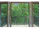 Balcony view overlooking a wall of mature shade trees for enhanced privacy at 26303 Plantation Ne Dr # 303, Atlanta, GA 30324