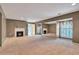 Large basement with carpet floors, fireplace, and a mirrored wall at 26303 Plantation Ne Dr # 303, Atlanta, GA 30324