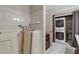 Bathroom featuring a walk-in bathtub, tiled walls, and a washer-dryer closet at 26303 Plantation Ne Dr # 303, Atlanta, GA 30324