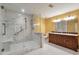Primary bathroom featuring a marble shower with safety grab bars and a double sink vanity at 26303 Plantation Ne Dr # 303, Atlanta, GA 30324