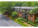 Well-maintained brick apartment building featuring manicured lawns and lush landscaping at 26303 Plantation Ne Dr # 303, Atlanta, GA 30324