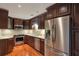 Stylish kitchen features stainless steel appliances, granite countertops, and dark wood cabinetry at 26303 Plantation Ne Dr # 303, Atlanta, GA 30324