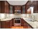 A well-equipped kitchen features stainless steel appliances, granite countertops, and dark wood cabinetry at 26303 Plantation Ne Dr # 303, Atlanta, GA 30324