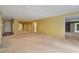 Spacious living room featuring neutral carpet, yellow walls, and multiple doorways at 26303 Plantation Ne Dr # 303, Atlanta, GA 30324