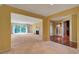 Open-concept living room with neutral walls, fireplace, carpeted floors, and sliding doors to a balcony at 26303 Plantation Ne Dr # 303, Atlanta, GA 30324
