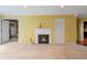 Living room features yellow walls, carpet floors, and a fireplace with white mantle at 26303 Plantation Ne Dr # 303, Atlanta, GA 30324