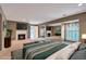 Staged main bedroom features a fireplace, large bed, and window views at 26303 Plantation Ne Dr # 303, Atlanta, GA 30324