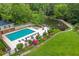 Community pool and patio area with lounge seating and lush landscaping at 26303 Plantation Ne Dr # 303, Atlanta, GA 30324