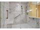Spacious marble shower featuring safety grab bars, seating, and dual shower heads at 26303 Plantation Ne Dr # 303, Atlanta, GA 30324