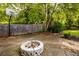 Backyard with basketball hoop and a fire pit and lush green trees at 2870 Livsey Woods Dr, Tucker, GA 30084