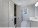 Bathroom featuring white vanity, toilet, and shower/tub combo with neutral-patterned shower curtain and hexagon tile floor at 2870 Livsey Woods Dr, Tucker, GA 30084