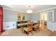 Elegant dining room with wainscoting, chair rail, hardwood floors, and modern chandelier at 2870 Livsey Woods Dr, Tucker, GA 30084