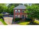 Charming brick two-story home with lush landscaping, a detached garage, and a welcoming front entrance at 2870 Livsey Woods Dr, Tucker, GA 30084
