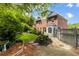Brick two story home featuring gorgeous landscaping and well manicured lawn at 2870 Livsey Woods Dr, Tucker, GA 30084