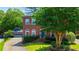 Charming two-story brick home with well-maintained landscaping, mature trees, and a detached two-car garage at 2870 Livsey Woods Dr, Tucker, GA 30084