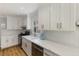 Well lit kitchen featuring white cabinets, herringbone backsplash, stainless steel appliances, and light countertops at 2870 Livsey Woods Dr, Tucker, GA 30084
