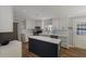 Spacious kitchen featuring white cabinets, herringbone backsplash, stainless steel appliances, light countertops, and a blue island at 2870 Livsey Woods Dr, Tucker, GA 30084