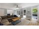 Comfortable living room with a large sectional, neutral decor, lots of natural light, and an open view of the kitchen at 2870 Livsey Woods Dr, Tucker, GA 30084