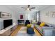 Cozy living room with ceiling fan, light-colored flooring, and large windows that provide natural light at 2870 Livsey Woods Dr, Tucker, GA 30084