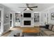 Bright living room showcasing a brick fireplace, built-in shelving, neutral tones, and an open layout at 2870 Livsey Woods Dr, Tucker, GA 30084