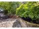 Backyard patio featuring stone flooring, a seating area, and a coy pond at 2870 Livsey Woods Dr, Tucker, GA 30084