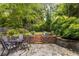 Backyard patio with stone flooring featuring a seating area and a coy pond at 2870 Livsey Woods Dr, Tucker, GA 30084