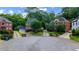 A street view showcases brick homes with mature trees, enhancing the neighborhood's curb appeal and inviting atmosphere at 2870 Livsey Woods Dr, Tucker, GA 30084
