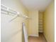 Well-organized walk-in closet features ample shelving and racks for optimal storage with an ironing board at 2870 Livsey Woods Dr, Tucker, GA 30084