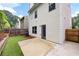 Backyard with a concrete patio, wood fence, and view of the back of the house at 403 Village Vw, Woodstock, GA 30188