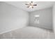Neutral bedroom with a ceiling fan, window and carpeted floor offers a serene space at 403 Village Vw, Woodstock, GA 30188
