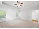 Bright and airy bedroom with shiplap wall and an ensuite bathroom and carpeted floors at 403 Village Vw, Woodstock, GA 30188