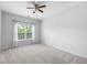 Large bedroom has bright natural light from the window, features carpeted floors and ceiling fan at 403 Village Vw, Woodstock, GA 30188