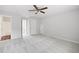 Spacious bedroom with carpet, fan, and door leading to bathroom at 403 Village Vw, Woodstock, GA 30188