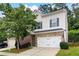 Two-story home with white siding, an attached garage, brick accents and a well-manicured front lawn at 403 Village Vw, Woodstock, GA 30188