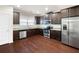 The kitchen features stainless steel appliances, granite countertops, and hardwood floors throughout at 403 Village Vw, Woodstock, GA 30188