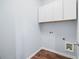 Functional laundry room with white cabinets and wood-look floors offers space-saving convenience at 403 Village Vw, Woodstock, GA 30188