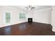Bright living room features a fireplace and a door to the backyard with a view at 403 Village Vw, Woodstock, GA 30188