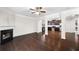 Inviting living room featuring a fireplace and hardwood floors, flowing into a modern kitchen at 403 Village Vw, Woodstock, GA 30188