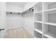 Walk-in closet features carpet, shelving, and hanging rods for storage at 403 Village Vw, Woodstock, GA 30188