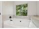 Relaxing soaking tub with a view of nature at 4967 Zoya Sw Ct, Atlanta, GA 30331